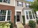 Brick and beige two-story townhome with black door at 744 Cupola Dr, Raleigh, NC 27603