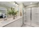 Modern bathroom with double vanity and a glass-enclosed shower at 219 Anise Ln, Garner, NC 27529