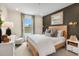 Cozy bedroom with wood bed frame, neutral color palette, and ample natural light at 219 Anise Ln, Garner, NC 27529