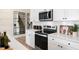 Modern kitchen with white cabinets, stainless steel appliances, and an island at 219 Anise Ln, Garner, NC 27529