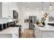 White kitchen with stainless steel appliances and an island at 219 Anise Ln, Garner, NC 27529
