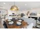 Open concept dining room with a long wooden table and view into the kitchen at 219 Anise Ln, Garner, NC 27529