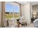 Bedroom sitting area with two armchairs and a view from a large window at 219 Anise Ln, Garner, NC 27529