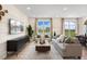 Spacious living room with large windows, comfortable seating, and a media console at 219 Anise Ln, Garner, NC 27529