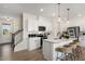 Modern kitchen with white cabinets, island, and hardwood floors at 219 Anise Ln, Garner, NC 27529
