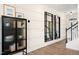 Elegant entryway with wood floors, black cabinet, and large mirrors at 219 Anise Ln, Garner, NC 27529