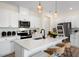 Modern kitchen with white cabinets, stainless steel appliances, and an island at 219 Anise Ln, Garner, NC 27529