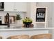 Modern kitchen features white cabinets, quartz countertops, and a black faucet at 219 Anise Ln, Garner, NC 27529