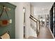 Light and airy entryway with green bench, powder room, and stairs at 219 Anise Ln, Garner, NC 27529