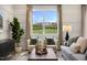 Bright living room with two armchairs, a sofa, and large windows at 219 Anise Ln, Garner, NC 27529