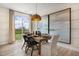 Bright dining area with a wooden table, four chairs, and a view of the backyard at 219 Anise Ln, Garner, NC 27529