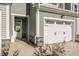 Front entry and attached garage with stone accents at 219 Anise Ln, Garner, NC 27529