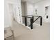 Modern staircase with metal railing and dark wood accents at 2408 Adrift Road, Fuquay Varina, NC 27526
