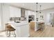 Modern kitchen with an island, white cabinets, and stainless steel appliances at 2408 Adrift Road, Fuquay Varina, NC 27526