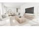 Bright living room features an open floor plan, hardwood floors, and a large TV at 2408 Adrift Road, Fuquay Varina, NC 27526
