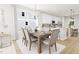 Bright dining room with a large table and access to the kitchen at 2408 Adrift Road, Fuquay Varina, NC 27526