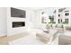 Living room featuring a modern fireplace and large windows at 2408 Adrift Road, Fuquay Varina, NC 27526