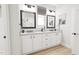 Double vanity bathroom with white cabinets and black hardware at 2408 Adrift Road, Fuquay Varina, NC 27526
