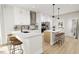 Modern kitchen with an island, white cabinets, and stainless steel appliances at 2408 Adrift Road, Fuquay Varina, NC 27526