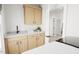 Well-lit laundry room with cabinets and countertop at 2408 Adrift Road, Fuquay Varina, NC 27526