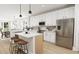 Modern kitchen with white cabinets, stainless steel appliances, and island at 2408 Adrift Road, Fuquay Varina, NC 27526