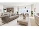 Open concept living room with neutral colored couch and a large window at 2412 Adrift Road, Fuquay Varina, NC 27526