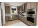 Modern kitchen with stainless steel appliances and farmhouse sink at 2412 Adrift Road, Fuquay Varina, NC 27526