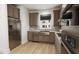 Modern kitchen with stainless steel appliances and farmhouse sink at 2412 Adrift Road, Fuquay Varina, NC 27526