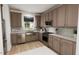 Modern kitchen with a farmhouse sink, stainless steel appliances and wood cabinets at 2412 Adrift Road, Fuquay Varina, NC 27526