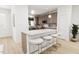 Modern kitchen with wood cabinets, stainless steel appliances, and an island with seating at 2412 Adrift Road, Fuquay Varina, NC 27526