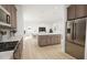 Open concept kitchen with island, stainless steel appliances and view into the living room at 2412 Adrift Road, Fuquay Varina, NC 27526