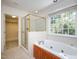 Bathroom with a large garden tub, shower, and window at 102 Preston Pines Dr, Cary, NC 27513