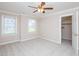 Bright bedroom with carpet flooring, ceiling fan, and a walk-in closet at 102 Preston Pines Dr, Cary, NC 27513