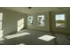 Bright, empty bedroom with three windows and protective floor covering at 1528 Maelyn Way, Fuquay Varina, NC 27526