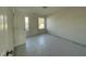 Empty bedroom with two windows, an open door, and protective floor covering at 1528 Maelyn Way, Fuquay Varina, NC 27526