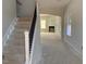 Elegant staircase with black spindles leading to the second floor at 359 N Maple Walk Dr # 210, Garner, NC 27529