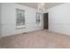 Spacious dining room with large windows and chandelier at 4621 Easthampton Dr, Raleigh, NC 27604