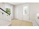 Bright entryway with stairs, coat closet and front door at 2404 Adrift Rd, Fuquay Varina, NC 27526