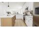 Modern kitchen with island, white cabinets and stainless steel appliances at 2400 Adrift Rd, Fuquay Varina, NC 27526