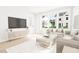 Bright living room features a large TV, comfortable seating, and plenty of natural light at 2400 Adrift Rd, Fuquay Varina, NC 27526