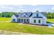 Single-story farmhouse with a gray exterior, white trim, and a covered porch at Tbd 1 Cedar Lane Rd, Sanford, NC 27332