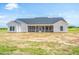 Rear view of a ranch house with a screened porch and large backyard at Tbd 1 Cedar Lane Rd, Sanford, NC 27332