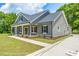 Gray farmhouse exterior with front porch and landscaping at Tbd 2 Cedar Lane Rd, Sanford, NC 27332