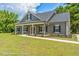 Gray farmhouse exterior with front porch and landscaping at Tbd 2 Cedar Lane Rd, Sanford, NC 27332