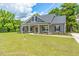 Gray farmhouse exterior with front porch and landscaping at Tbd 2 Cedar Lane Rd, Sanford, NC 27332