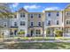 Three-story townhouses with white picket fences and landscaped yards at 401 Coalinga Ln # 109, Raleigh, NC 27610