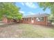Brick ranch house with landscaping and a large yard at 2171 Bud Lipscomb Rd, Willow Springs, NC 27592