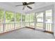 Spacious screened porch with a ceiling fan and carpet at 2171 Bud Lipscomb Rd, Willow Springs, NC 27592