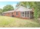 Brick house with screened porch and large backyard at 2171 Bud Lipscomb Rd, Willow Springs, NC 27592