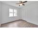 Bedroom with hardwood floors, ceiling fan and double door closet at 2171 Bud Lipscomb Rd, Willow Springs, NC 27592
